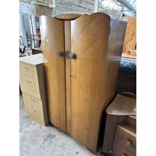 15 - A mid 20th century Lebus oak three piece bedroom suite