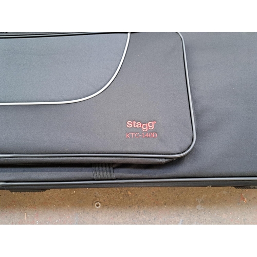 791 - Two items, one Stagg KTC-140D keyboard case with wheels (RRP £199) and one boxed keyboard stand