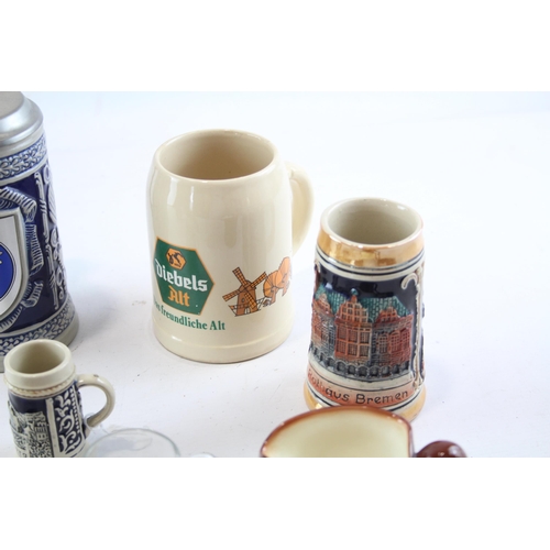 386 - Nine ceramic and glass mugs to include Royal Doulton Old Charley, Royal Doulton Desperate Dan, Germa... 