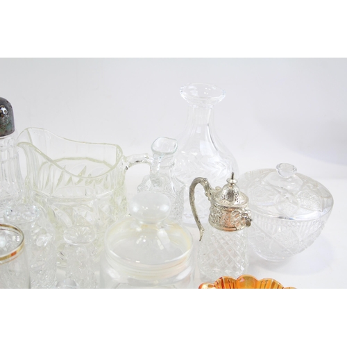 387 - A collection of kitchenware to include cut glass sugar shaker, bottles, jug etc.