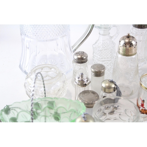 387 - A collection of kitchenware to include cut glass sugar shaker, bottles, jug etc.