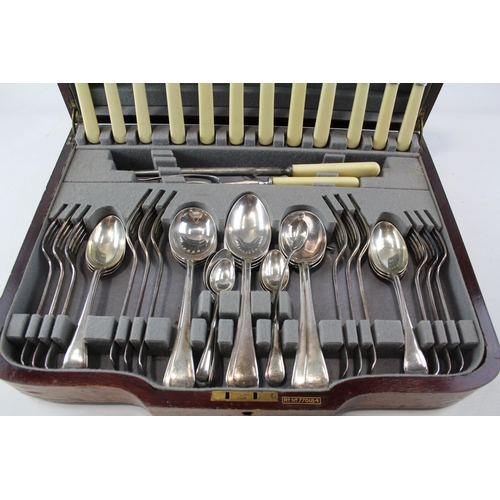 442 - A vintage ivorine fifty three piece carving cutlery set in wooden canteen