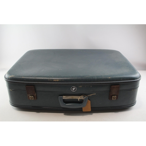 579A - A vintage suitcase containing a collection of Ladybird books