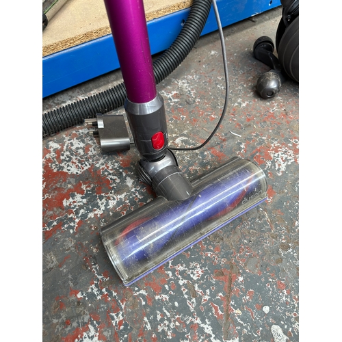 856 - A Dyson V7 cordless bagless vacuum cleaner with charger and attachments