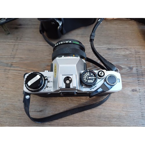 688 - Three cameras, one cased Olympus OM10 35mm SLR fitted with Zuiko MC Auto-S 1:1.8 f=50mm lens, one Ko... 