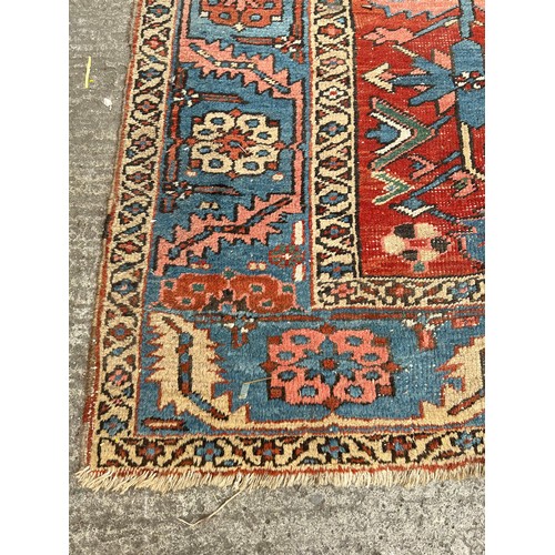 27 - An antique Persian hand knotted rug - approx. 360cm x 305cm