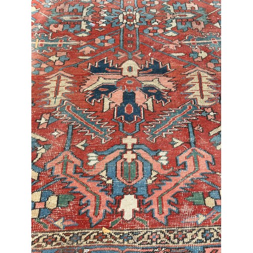 27 - An antique Persian hand knotted rug - approx. 360cm x 305cm