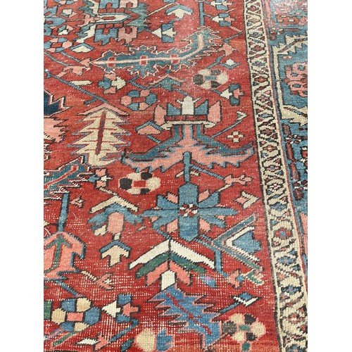 27 - An antique Persian hand knotted rug - approx. 360cm x 305cm