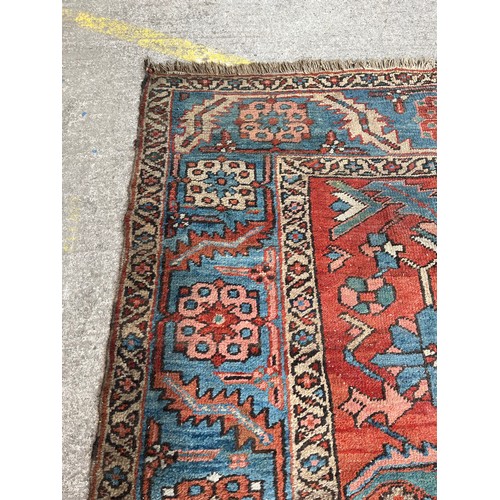 27 - An antique Persian hand knotted rug - approx. 360cm x 305cm