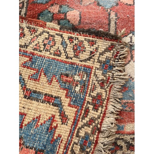 27 - An antique Persian hand knotted rug - approx. 360cm x 305cm