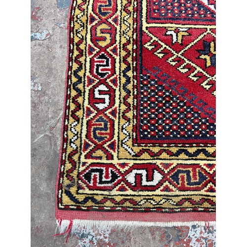 107 - A mid 20th century hand knotted rug - approx. 130cm x 86cm