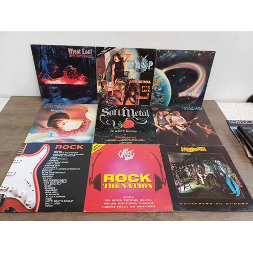 769 - A collection of vinyl records, music DVDs and a CD to include ACϟDC, W.A.S.P., Rainbow, Marillion, D... 