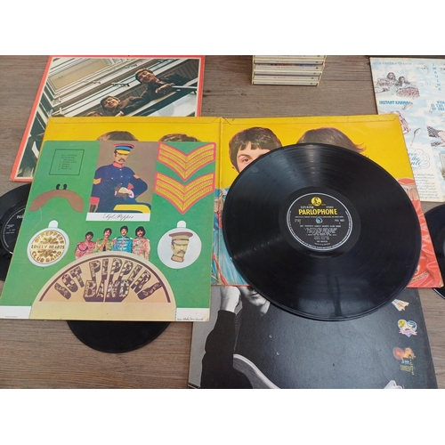 772 - A collection of The Beatles and related vinyl records and CDs to include 'Sgt. Pepper's Lonely Heart... 