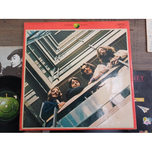 772 - A collection of The Beatles and related vinyl records and CDs to include 'Sgt. Pepper's Lonely Heart... 