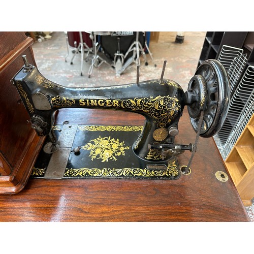 832 - An 1895 Singer treadle sewing machine with cast iron base