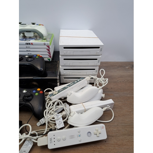 807 - A collection of video game consoles, games, controllers and accessories to include four Nintendo Wii... 