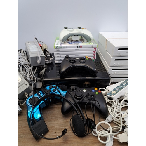 807 - A collection of video game consoles, games, controllers and accessories to include four Nintendo Wii... 