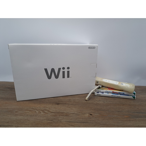 809 - A boxed Nintendo Wii console with controllers, games and third-party fitness board