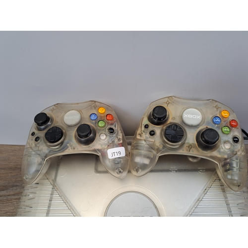 813 - An Xbox Crystal translucent console with two Crystal translucent controllers