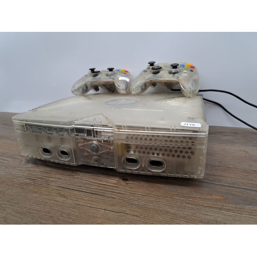 813 - An Xbox Crystal translucent console with two Crystal translucent controllers