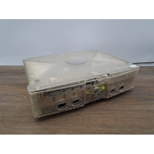 813 - An Xbox Crystal translucent console with two Crystal translucent controllers