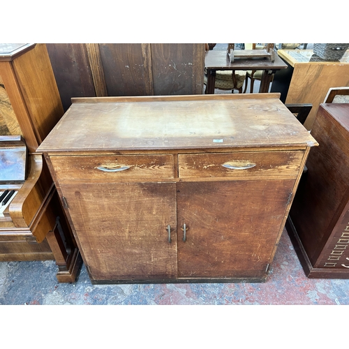 202 - A mid 20th century pine and plywood sideboard - approx. 102cm high x 111cm wide x 50cm deep