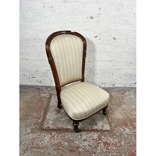 203 - A Victorian rosewood and fabric upholstered bedroom chair on turned supports and castors