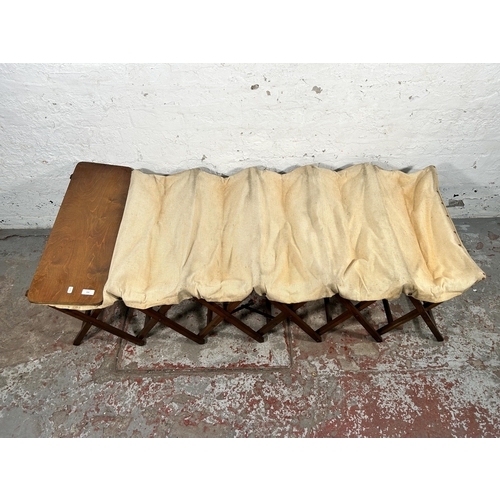 205 - A vintage wooden and canvas folding bed - approx. 60cm high x 70cm wide x 184cm long