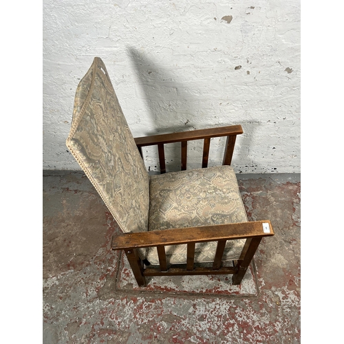 224 - A mid 20th century beech and floral upholstered reclining armchair