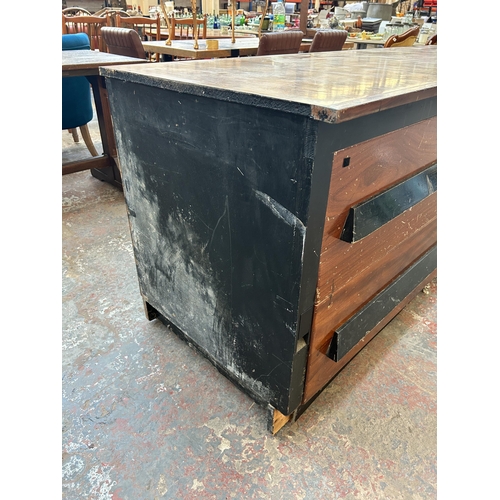 232 - A mid 20th century walnut effect and ebonised four drawer shop counter - approx. 85cm high x 205cm w... 