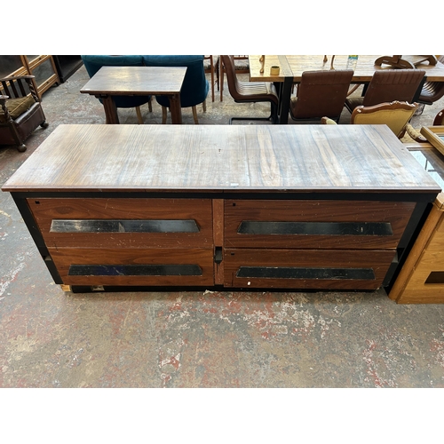 232 - A mid 20th century walnut effect and ebonised four drawer shop counter - approx. 85cm high x 205cm w... 