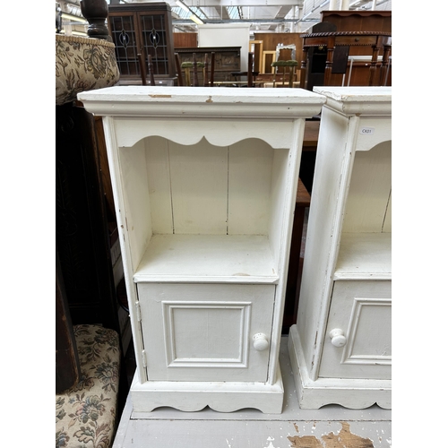 102 - A pair of white painted pine bedside cabinets