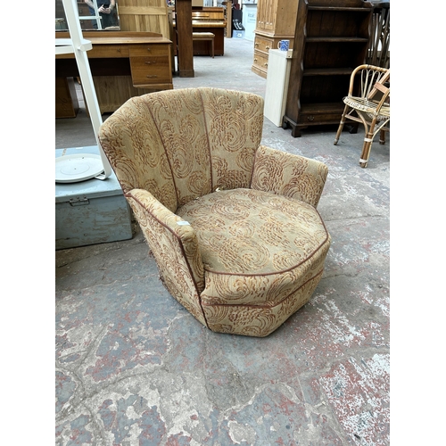 109 - A mid 20th century fabric upholstered fan back arm chair