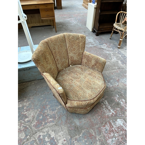 109 - A mid 20th century fabric upholstered fan back arm chair