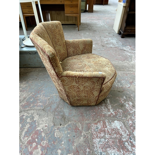 109 - A mid 20th century fabric upholstered fan back arm chair