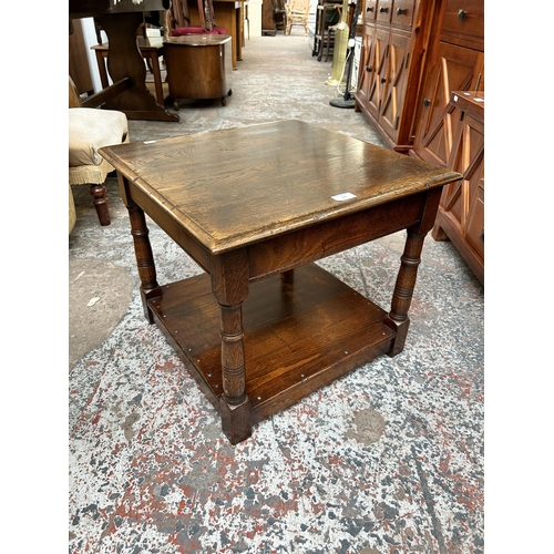 119 - A 17th century style solid oak two tier side table with turned supports - approx. 46cm high x 53cm w... 