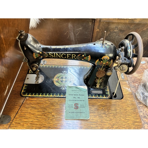 124 - An early 20th century Singer treadle sewing machine with cast iron and oak table - serial no. F88384... 