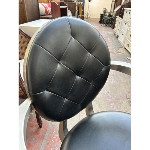 143 - A brushed steel and black vinyl salon chair