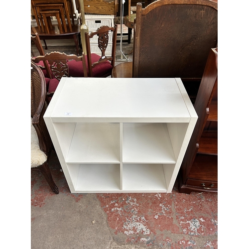 145 - An IKEA Kallax white laminate shelving unit - approx. 76cm high x 76cm wide x 39cm deep