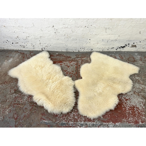 157 - Two sheepskin rugs, one 110cm x 63cm and one 107cm x 73cm