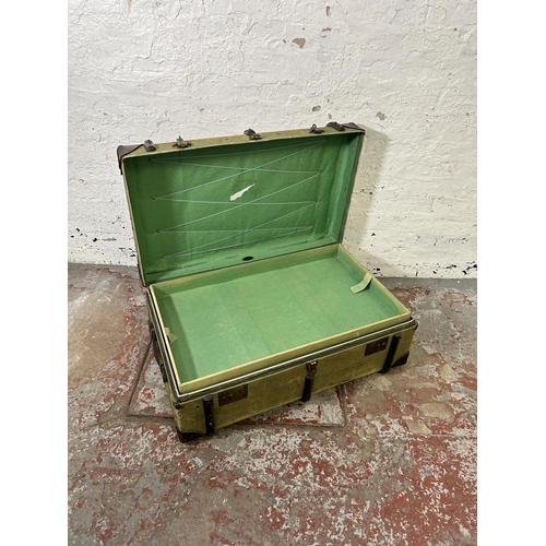 175 - A vintage Flaxite Foundation green canvas and wooden banded travel trunk