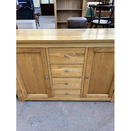 178 - A modern oak sideboard - approx. 95cm high x 147cm wide x 45cm deep