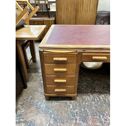 19 - A 1930s oak and red leather partner's desk - approx. 79cm high x 152cm wide x 125cm deep