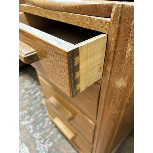 19 - A 1930s oak and red leather partner's desk - approx. 79cm high x 152cm wide x 125cm deep