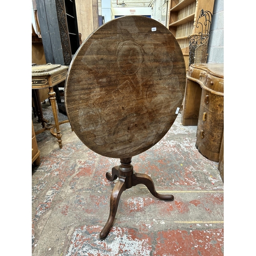 20 - A Georgian mahogany circular tilt top tripod occasional table - approx. 109cm high x 68cm diameter