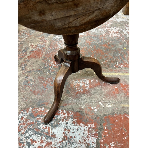 20 - A Georgian mahogany circular tilt top tripod occasional table - approx. 109cm high x 68cm diameter