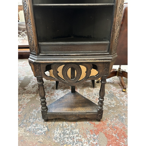 24 - A 19th century carved oak corner cabinet on stand - approx. 178cm high x 85cm wide x 50cm deep