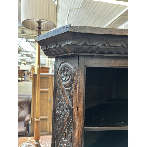 24 - A 19th century carved oak corner cabinet on stand - approx. 178cm high x 85cm wide x 50cm deep