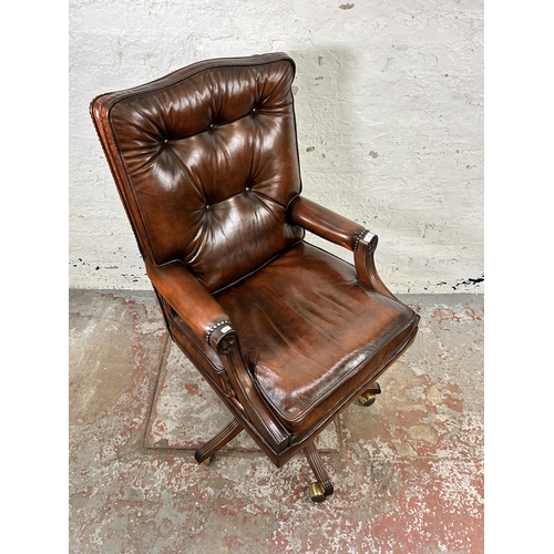 25 - A Bevan Funnell Reprodux brown leather and mahogany swivel office desk chair