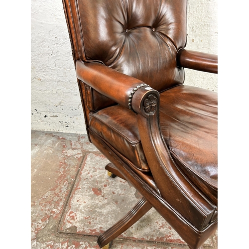 25 - A Bevan Funnell Reprodux brown leather and mahogany swivel office desk chair